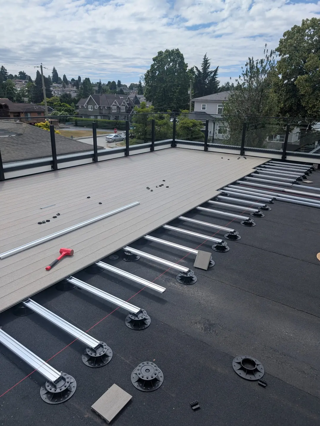 Pedestals and joists running beneath the first section of the deck.