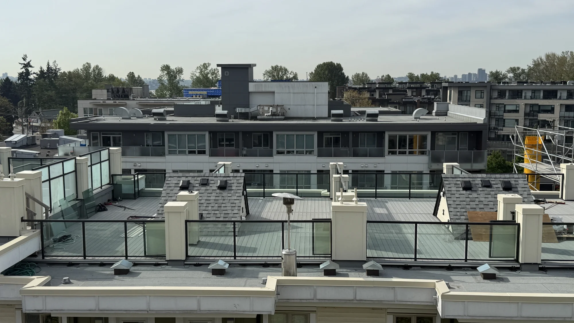 NOMA rooftop patios with grey composite decking across multiple apartment buildings