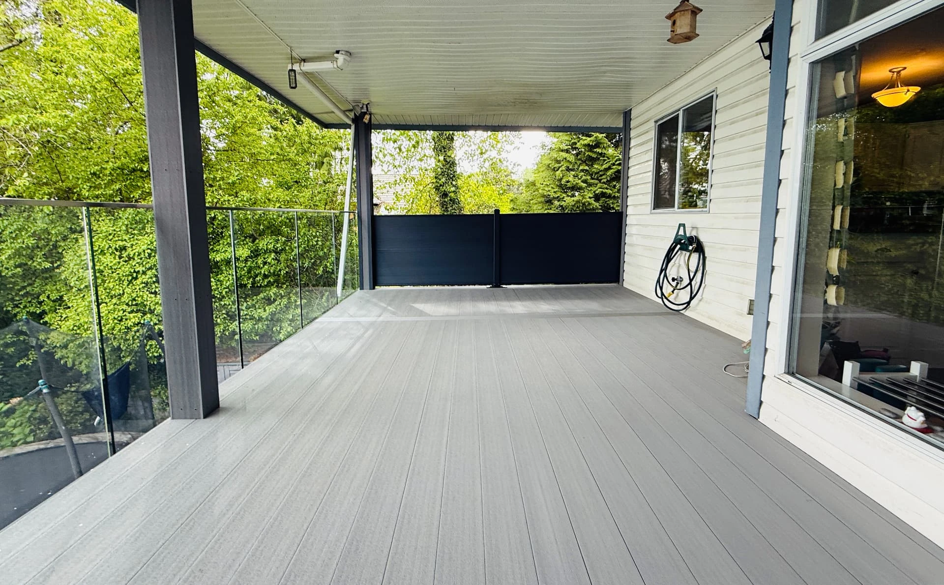 The finished covered deck alongside the home.