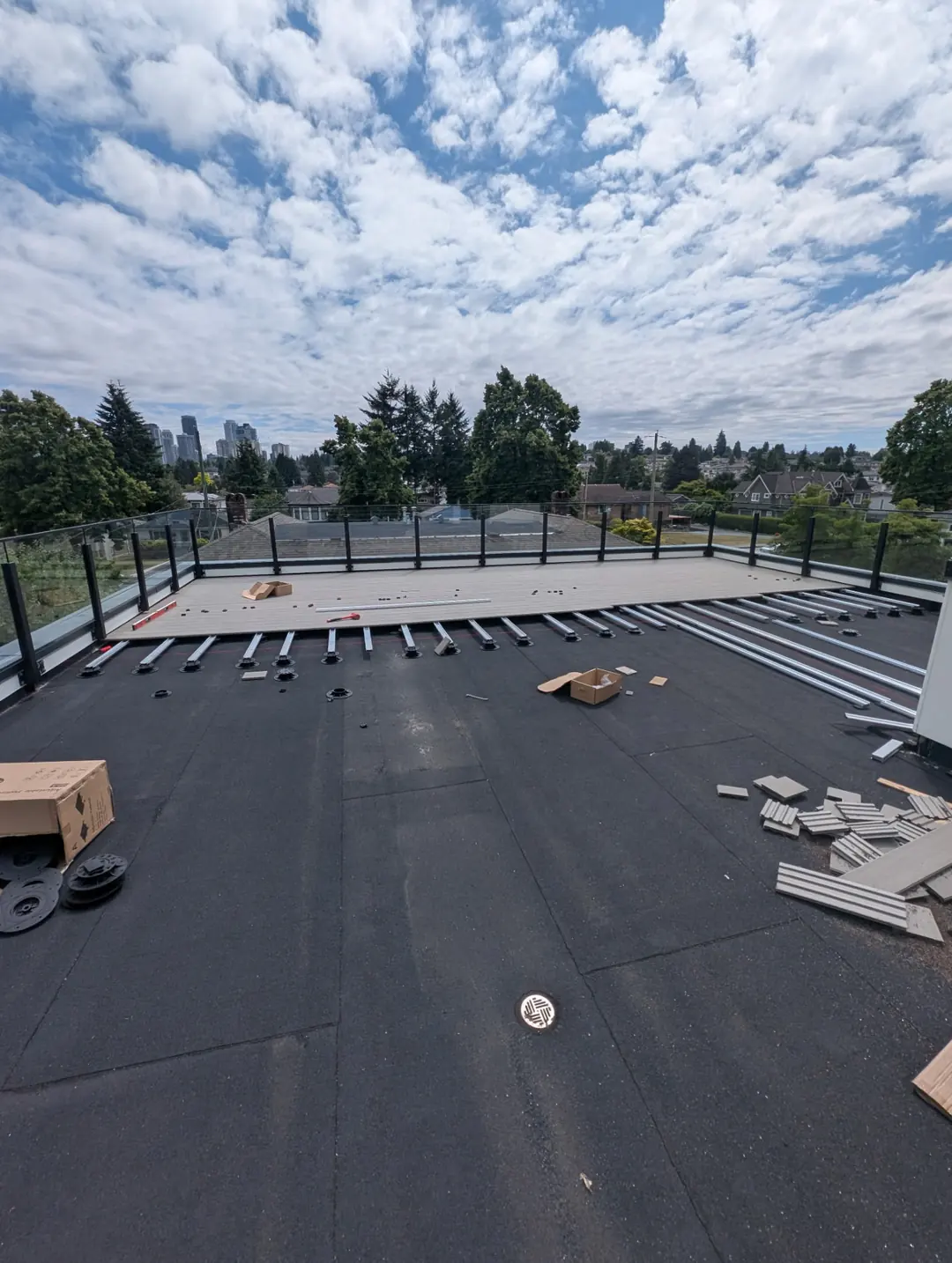The rooftop deck opening toward the surrounding neighbourhood and skyline.